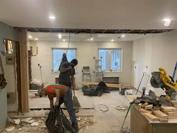 The fully opened sightline from the living room straight through to the twin kitchen windows after the dividing wall removal in Bayside