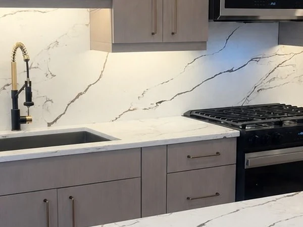 Detail of the finished cabinetry run with quartz counters, undermount sink and stainless range in the Bayside apartment