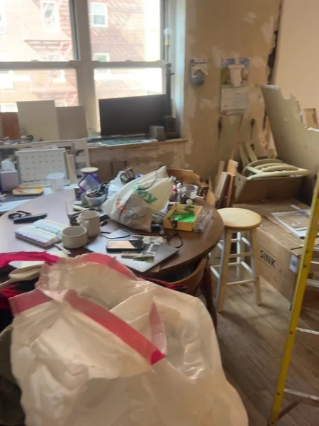 The Bayside apartment before work started, filled with years of belongings, keepsakes and paperwork awaiting phased sorting