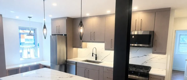 Wide view of the completed open-concept Bayside apartment kitchen
