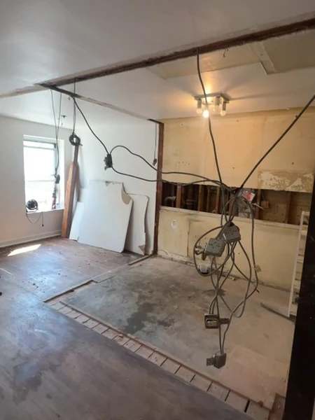 The expanded opening framed out and the ceiling shored with temporary posts while the new structural support went in
