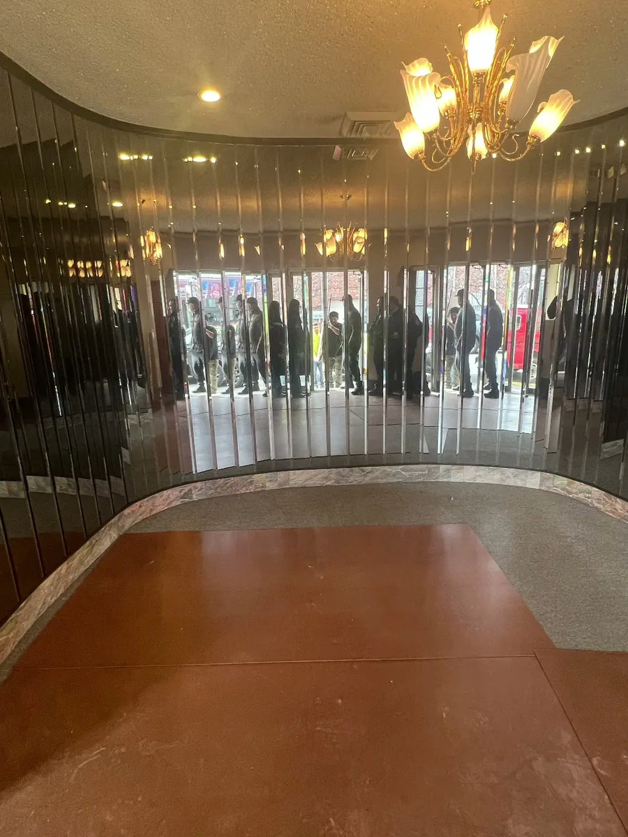 The mirrored lobby wall before work began.