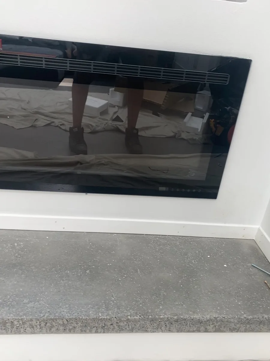 Linear fireplace set into its prepared aperture.