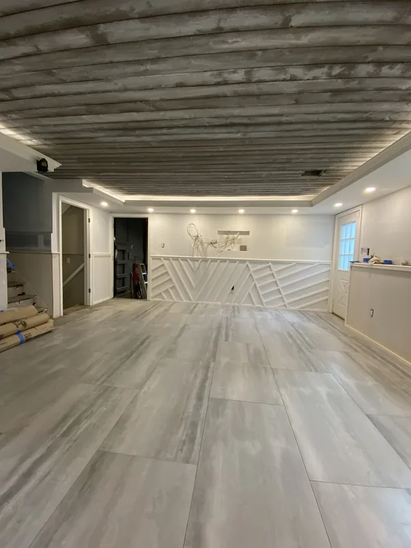View down the full length of the finished family room, unfurnished.