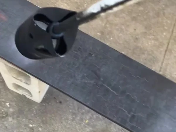 Torch head working along a cedar board during the shou sugi ban charring process