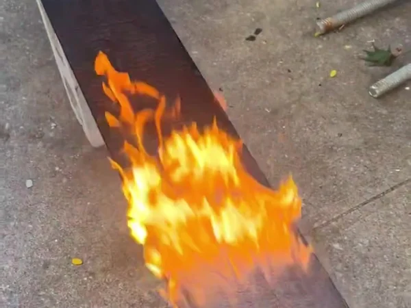 Open flame running down the face of a cedar board being charred for a shou sugi ban finish
