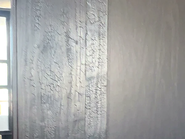 Close-up of the finished charred cedar closet door face, showing the cracked alligator-skin texture raised by the shou sugi ban burn