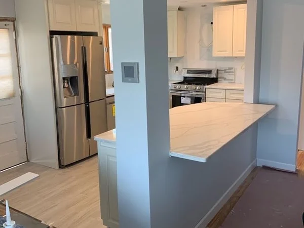 Progress: new cabinetry, quartz peninsula and stainless appliances installed, finish work underway